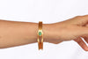 Gold plated bracelet with an emerald stone. Modern design