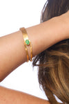 Gold plated bracelet with an emerald stone. Modern design