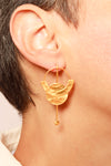 Lunar Spell drop earrings featuring moon phases in brushed gold with geometric bar detail in ear 