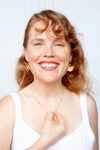 Ruby Crown Half-Moon Earring styled on ear, demonstrating how the gold fan shape frames the face