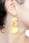 Side profile of Casey triple-tier earrings showing graduated disc arrangement