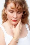 Dual-wear spiral earrings demonstrating transformation between spiral and waterfall styles